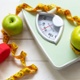 scales, tape measure and apples
