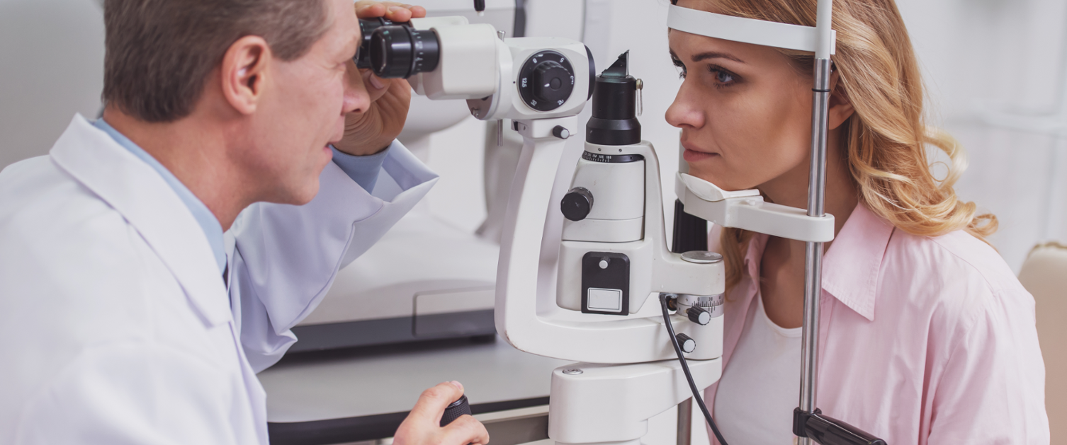 Optometrist looking at patient