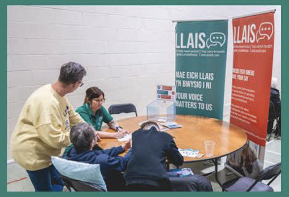 people around a table with pop up banners