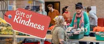 Gift of Kindness Banner - Woman gifting food to another person