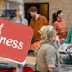 Gift of Kindness Banner - Woman gifting food to another person