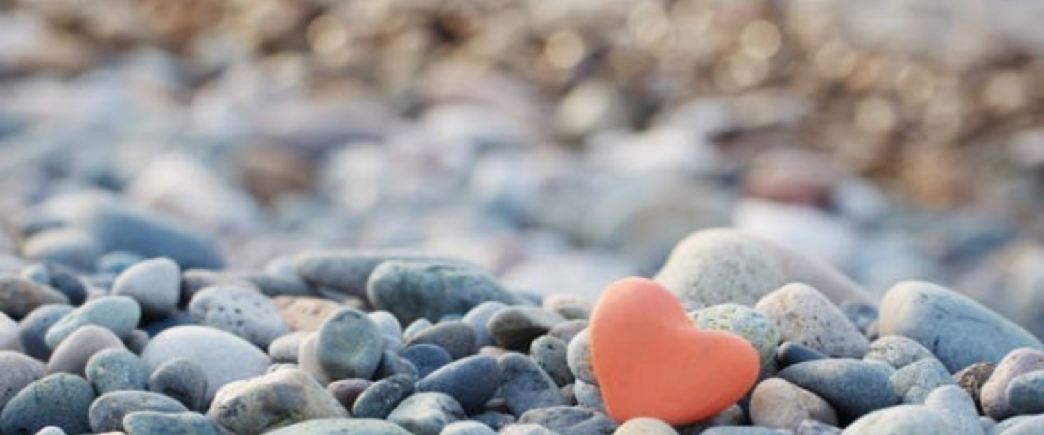 Love heart amongst scattered pebbles