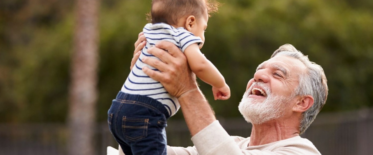 Man holding up his grandchild