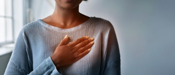 woman holding chest