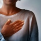 woman holding chest