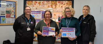 CTM staff with Help Me Quit Posters