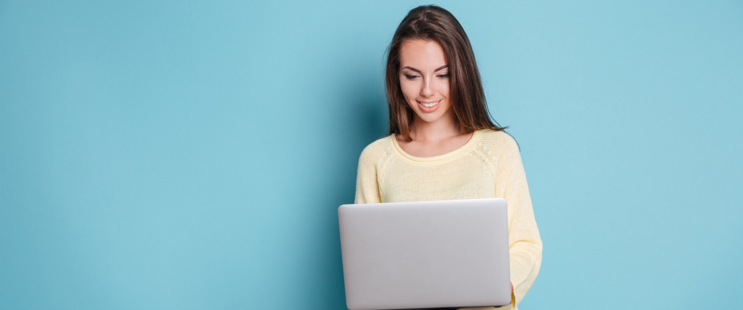 Young woman with laptop, smiling