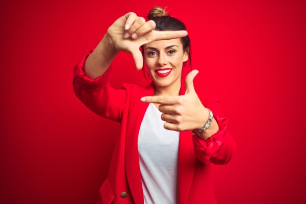Woman smiling on a red background<br>