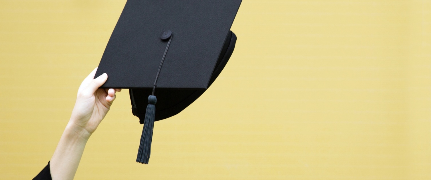 Graduate cap on yellow background