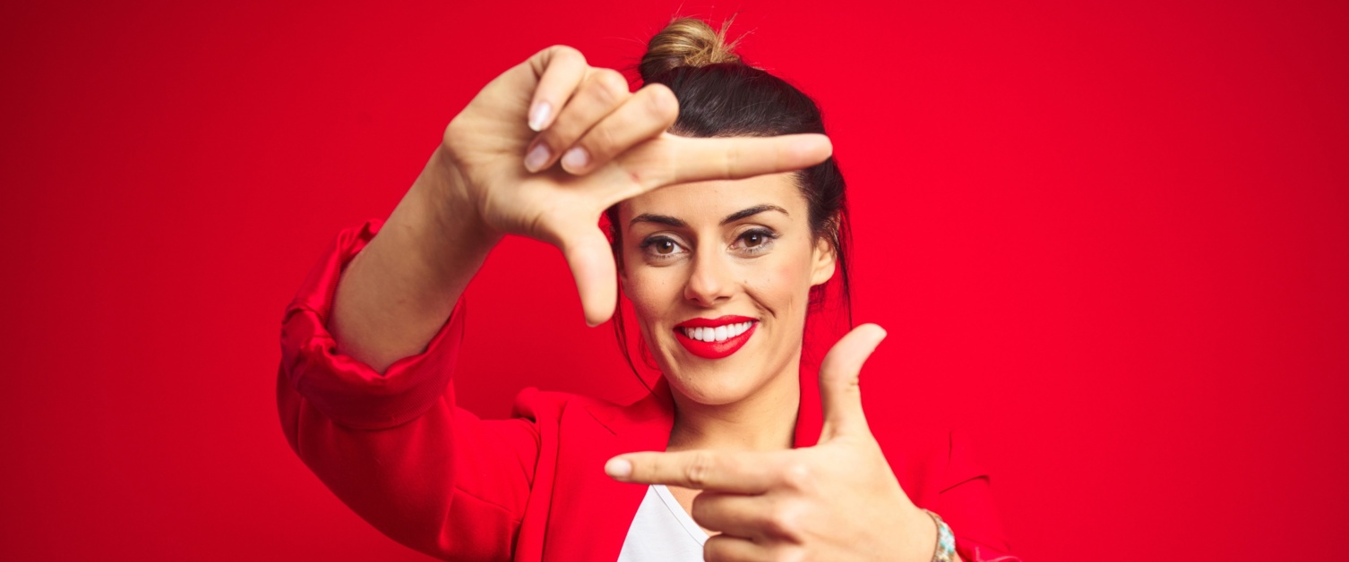 Woman smiling on a red background