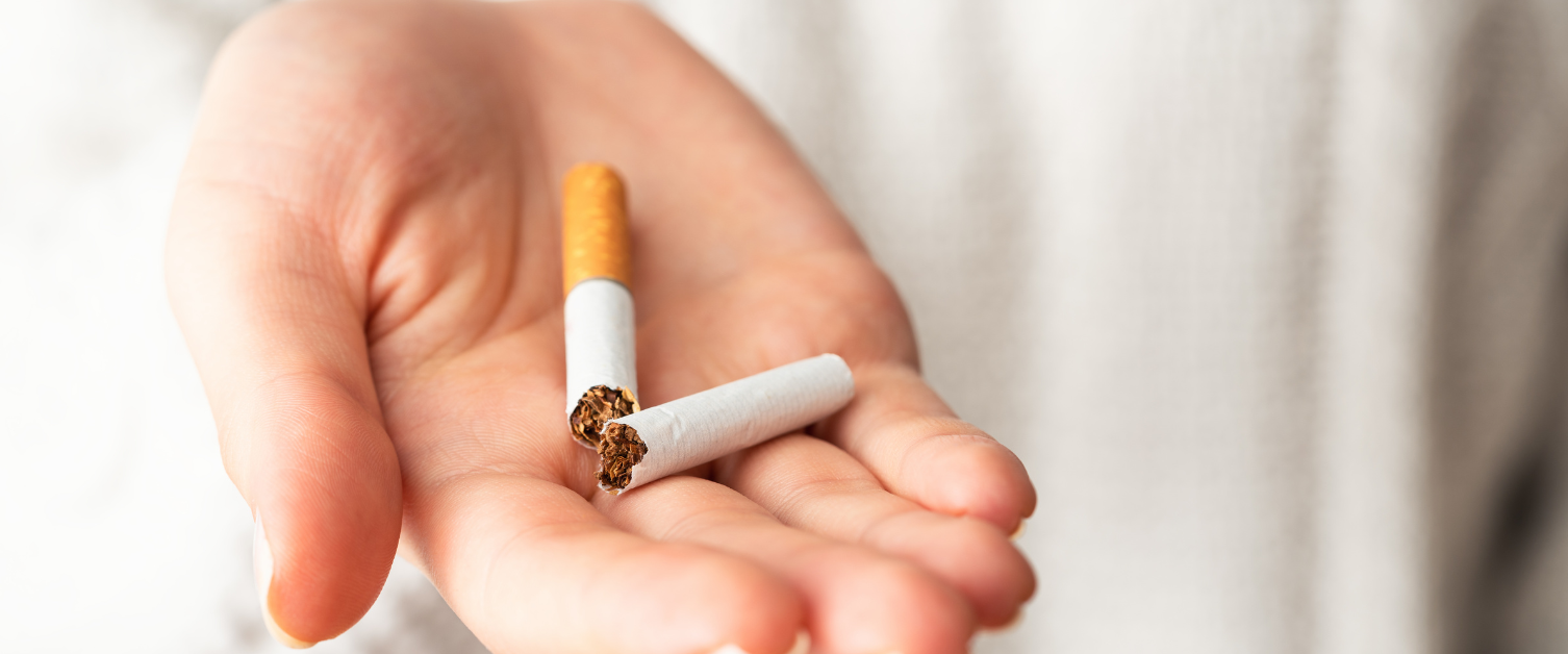 hand holding a broken cigarette
