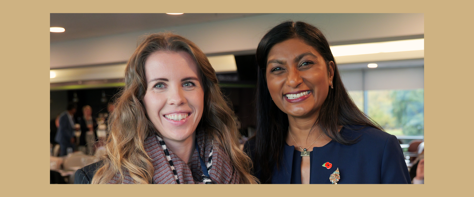 Angharad Hanbury (left) stands with her award, next to Sue Tranka, the Chief Nursing Officer (right). They both have a smile on their face.