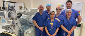 Group of nurses standing next to the new robot