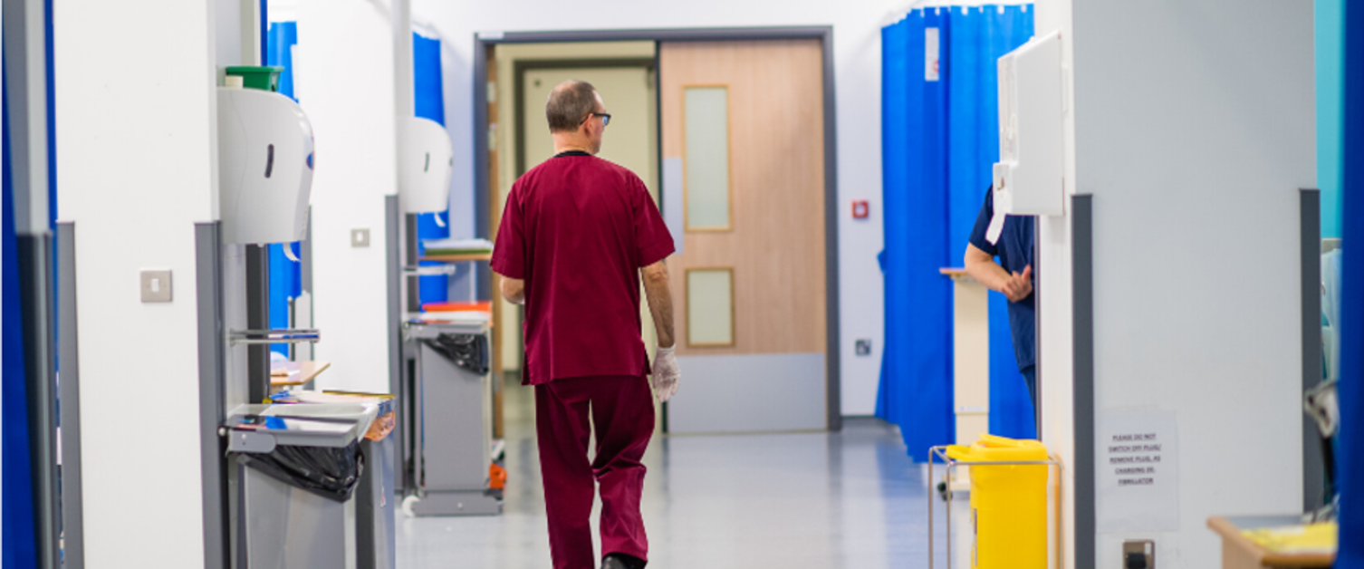 Gentleman walking through hospital ward