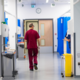 Gentleman walking through hospital ward