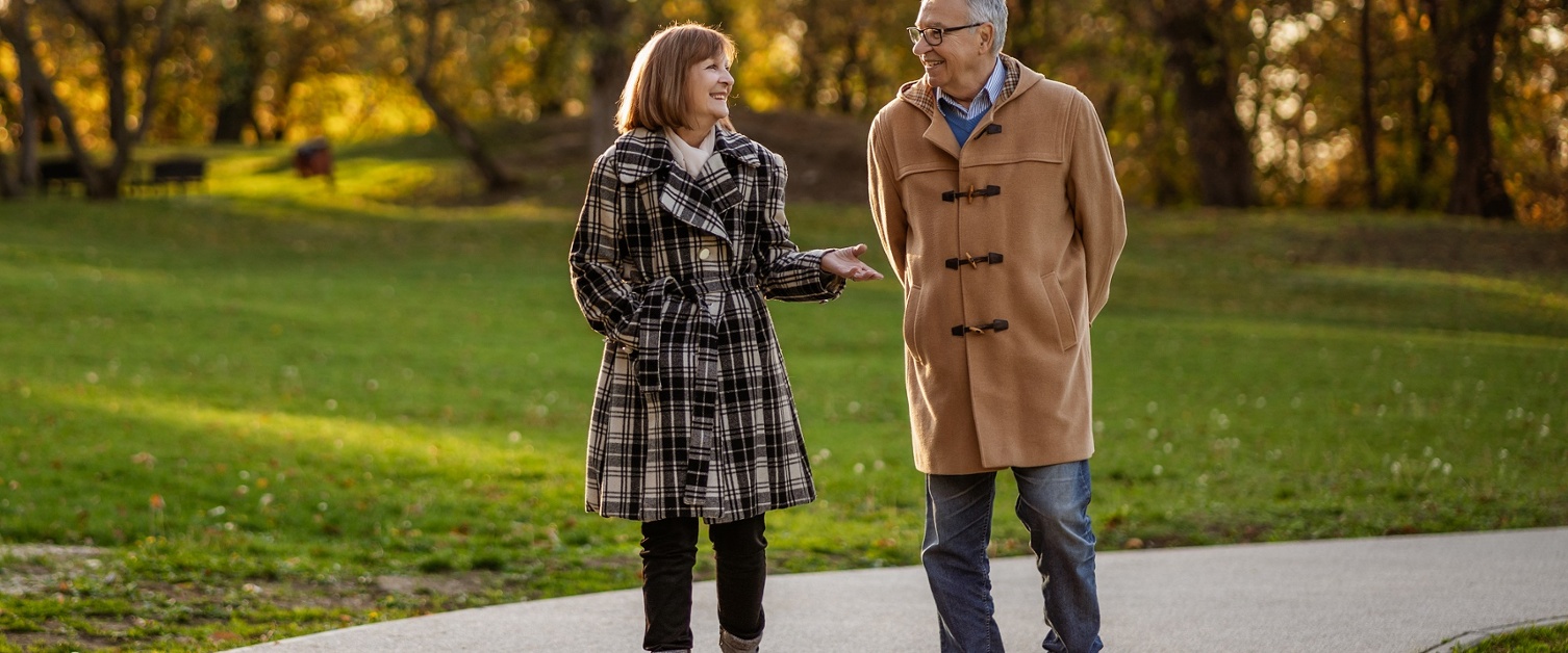 Two people chatting while walking in the park