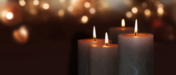 Lit candles against a dark background