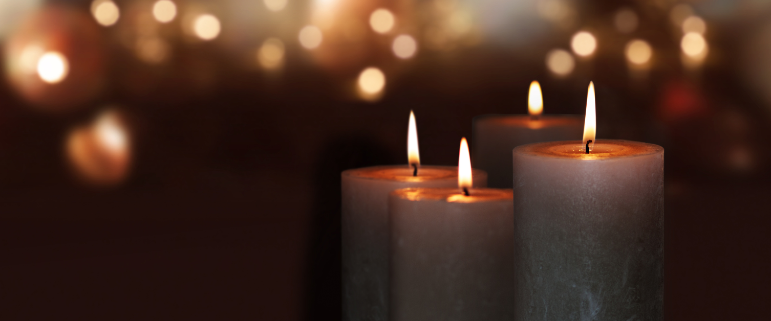 Lit candles against a dark background