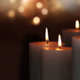 Lit candles against a dark background