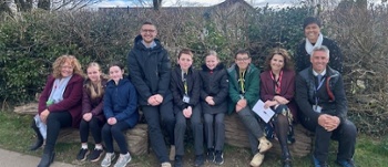 Group of staff and students sitting outside school