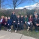 Group of staff and students sitting outside school