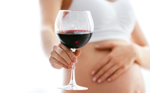 pregnant person holding wine glass