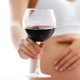 pregnant person holding wine glass