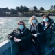 3 nurses on a boat to Caldey Island to deliver the second round of vaccines