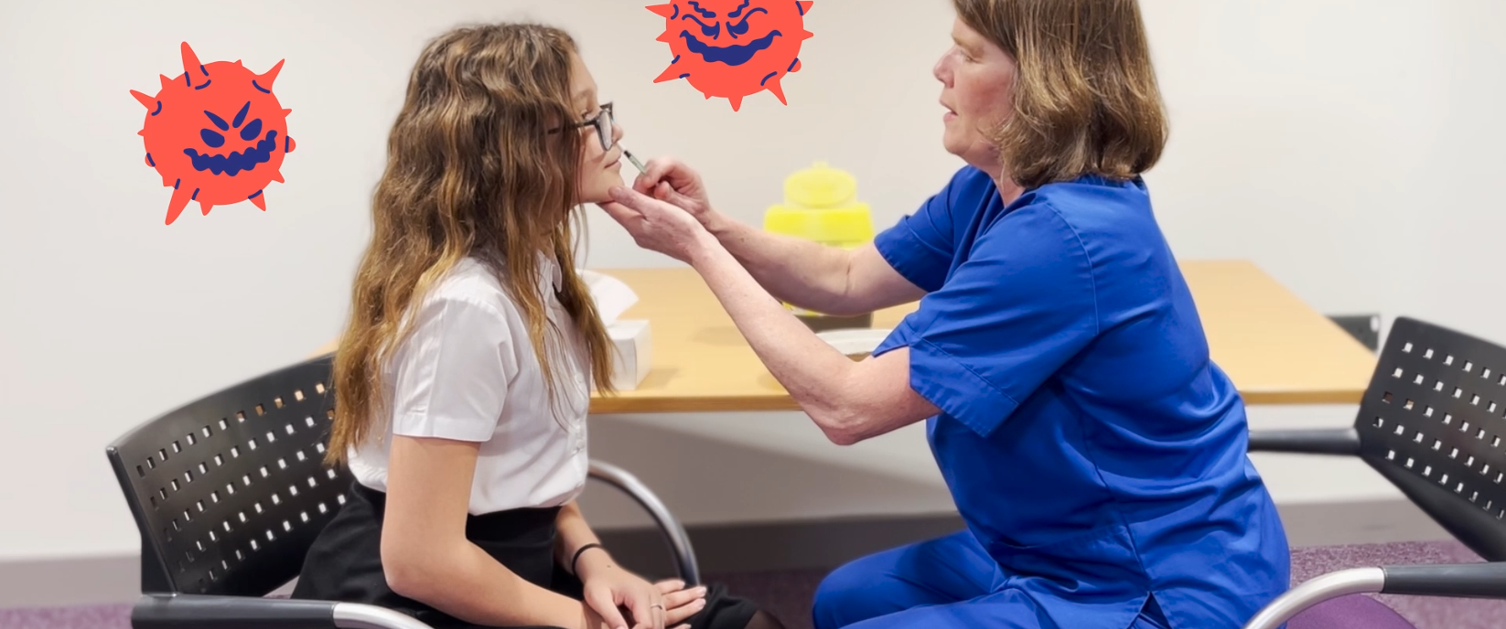 school child having flu nasal spray