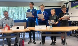 Children presenting in boardroom