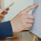 A person is pointing to a date on a calendar