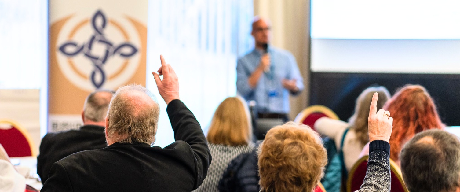 Hands raised to ask question at event
