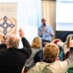 Hands raised to ask question at event