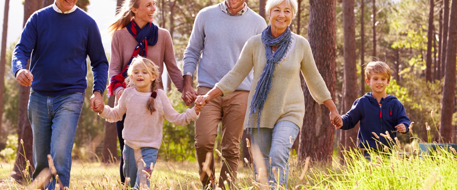 family gently running through the woods