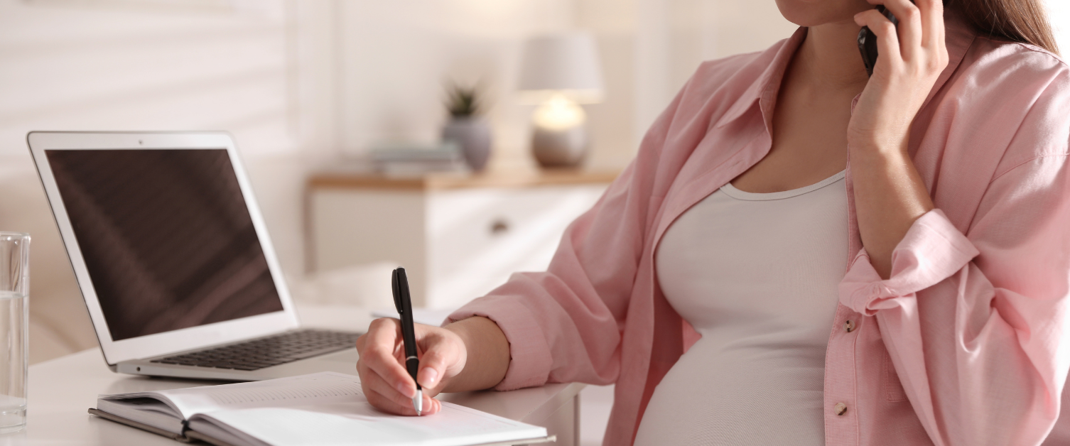 pregnant person writing in notebook