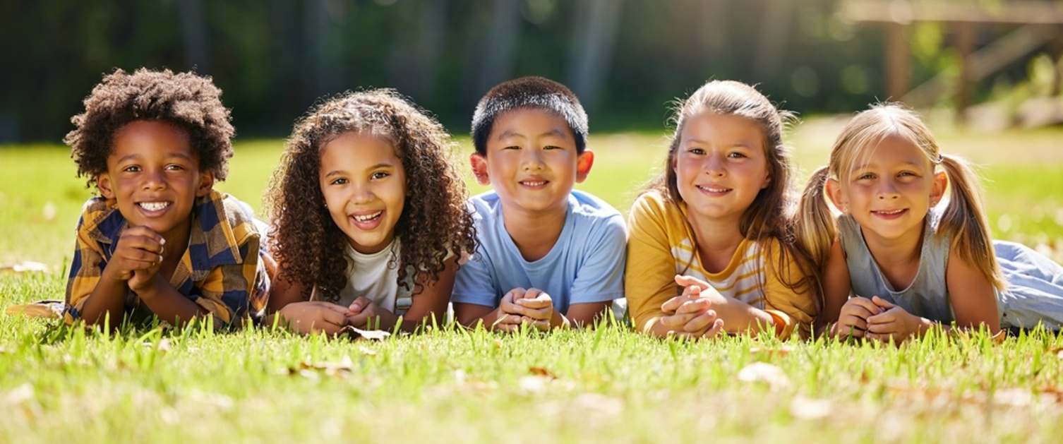 Group of children lying on the grass