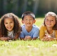 Group of children lying on the grass