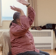 People exercising whilst sitting on chairs