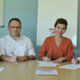 People sitting at table signing paper