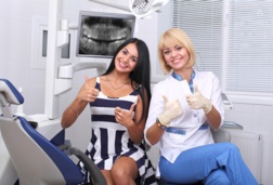 Dentist with patient smiling