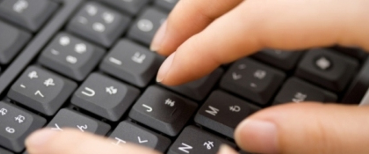 Closeup of hand typing on a keyboard