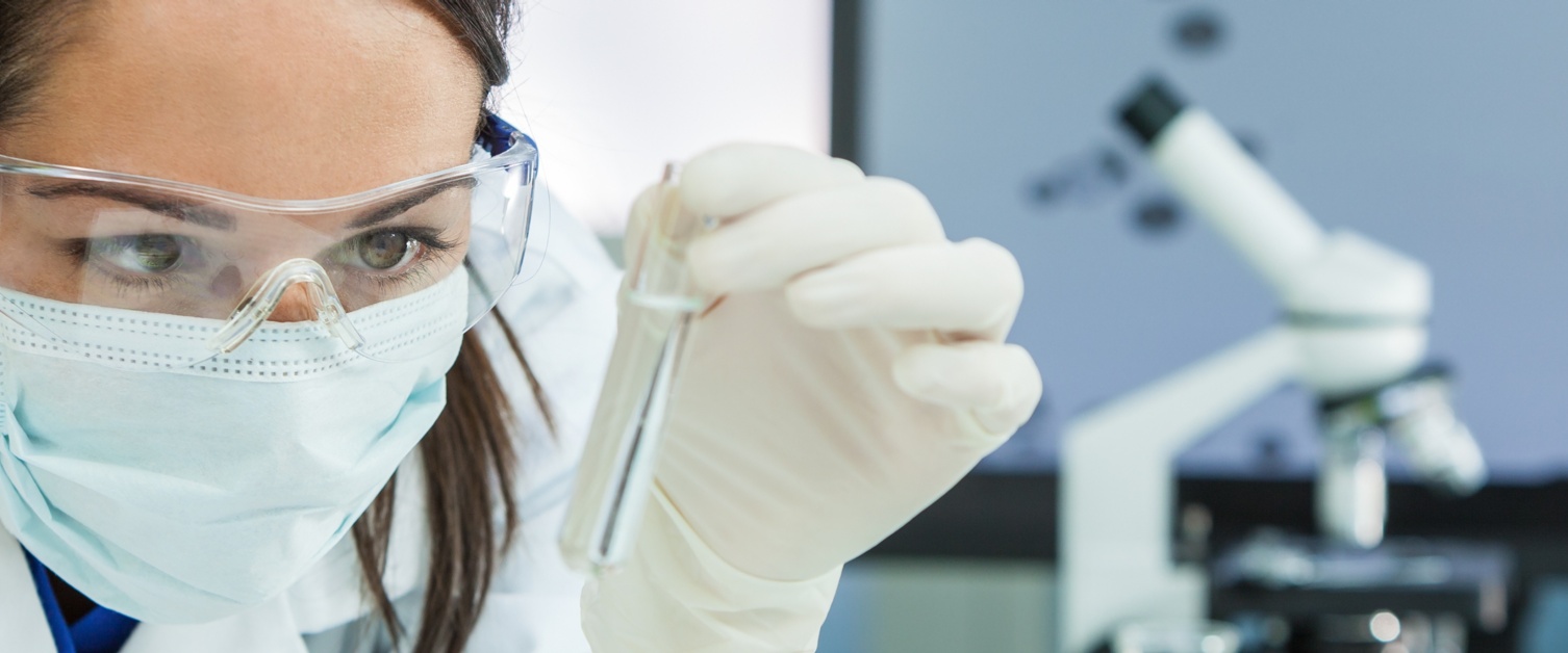 Woman in mask with a test tube