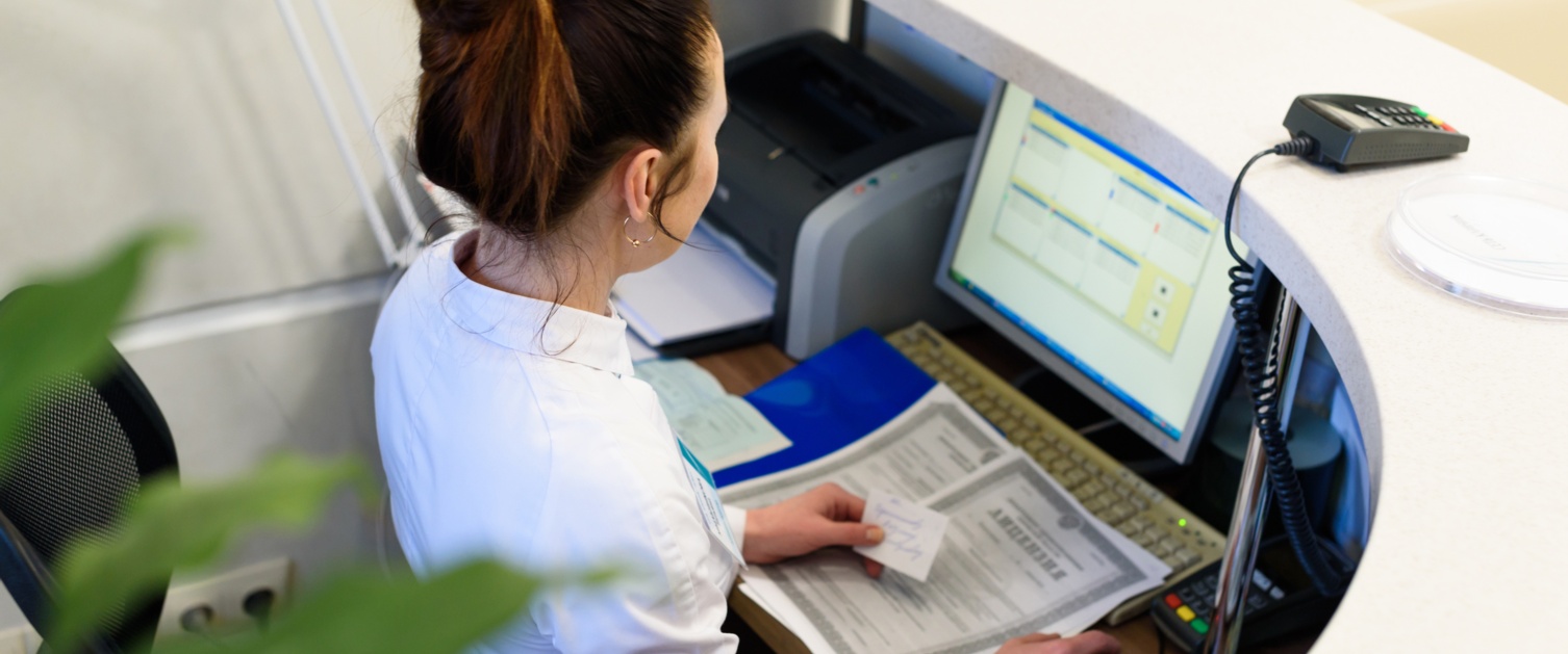 Female receptionist working the computer