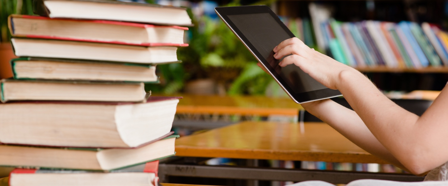 Hands using tablet in library