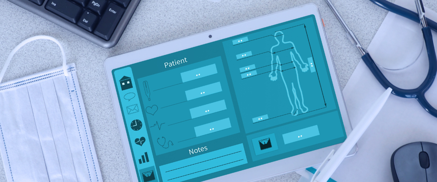 Medical equipment, like stethoscopes, pills and masks on a table with a digital screen, keyboard and mouse.