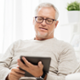 Elderly man viewing a digital tablet