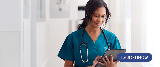 Clinician with her hair tied back holding a tablet