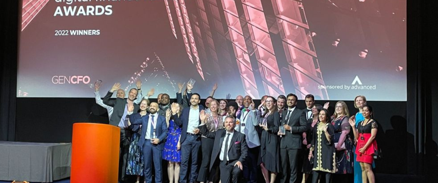 Image of a group of people on stage, including Claire Osmundsen-Little who won the award for finance leader of the year.