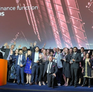 Image of a group of people on stage, including Claire Osmundsen-Little who won the award for finance leader of the year.
