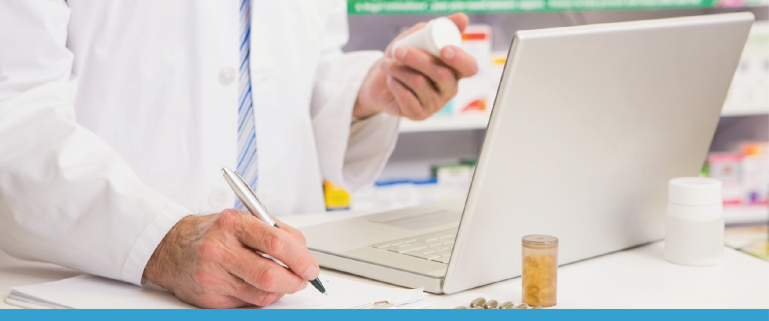 Pharmacist working on a laptop / Fferyllydd yn gweithio ar liniadur